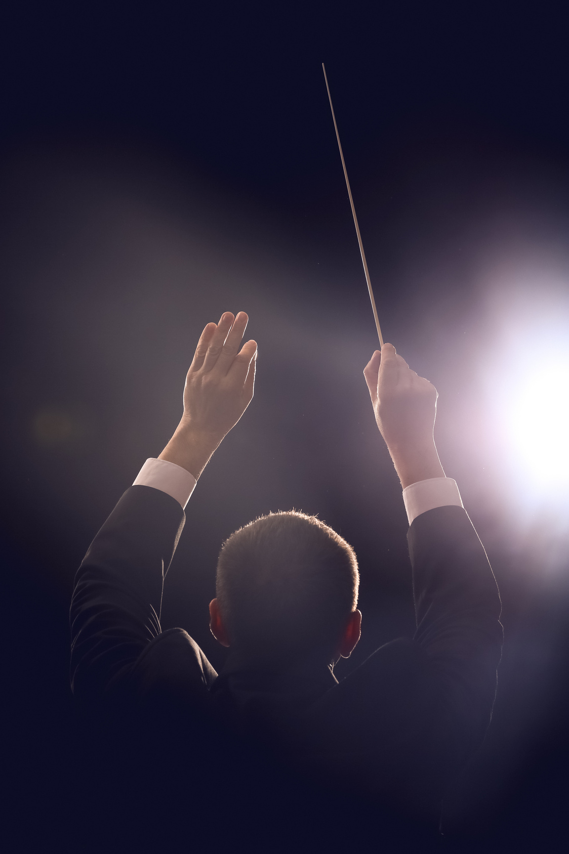 Male Conductor on Dark Background